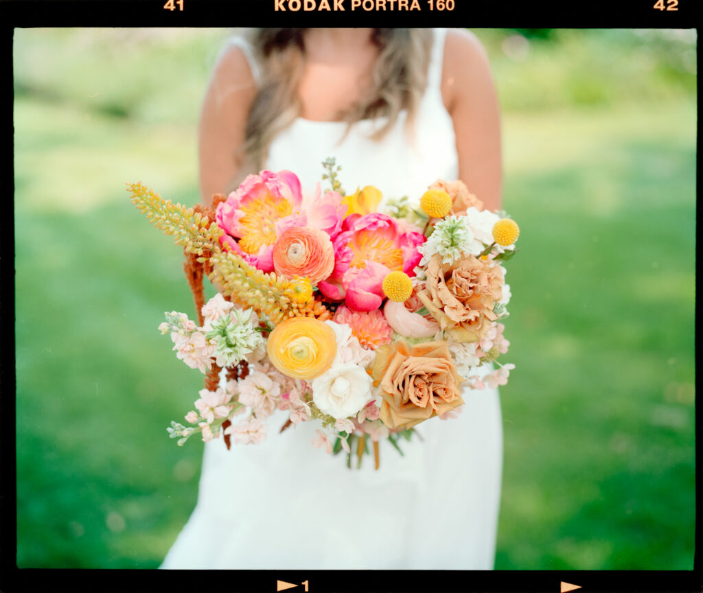 bride holding bokeh with spring colors on film
