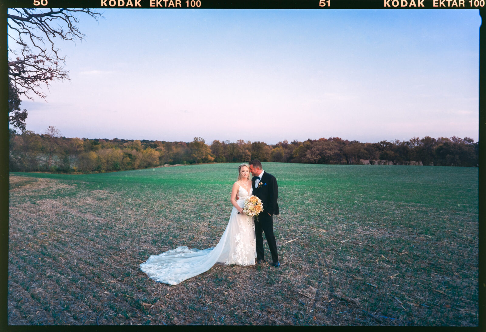 Bride and groom cuddling up in film photograph on a farm